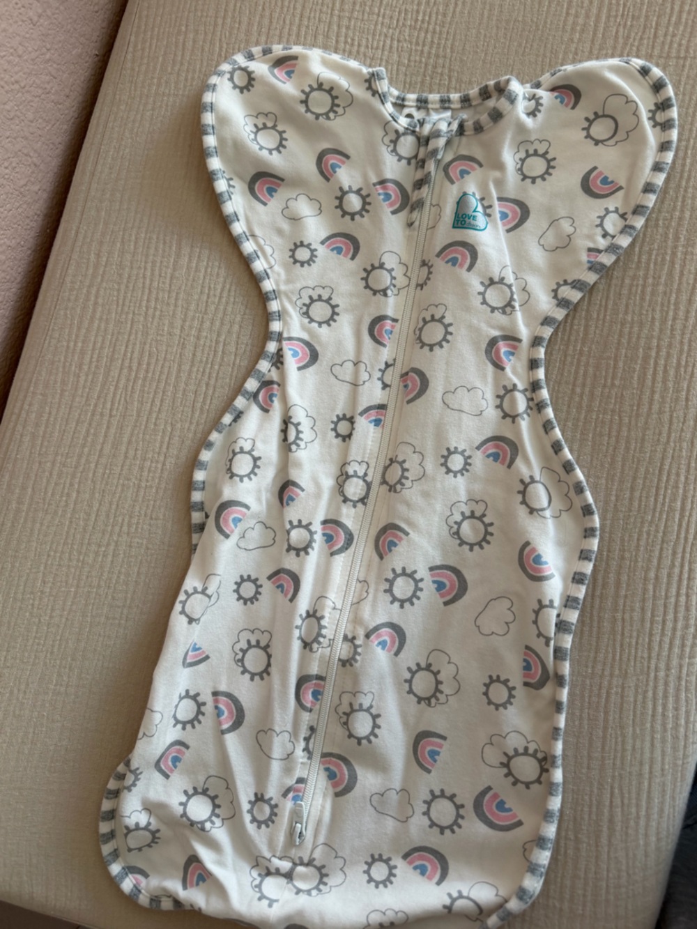 Love to dream white swaddle sleepsuit with gray trim and pink rainbows